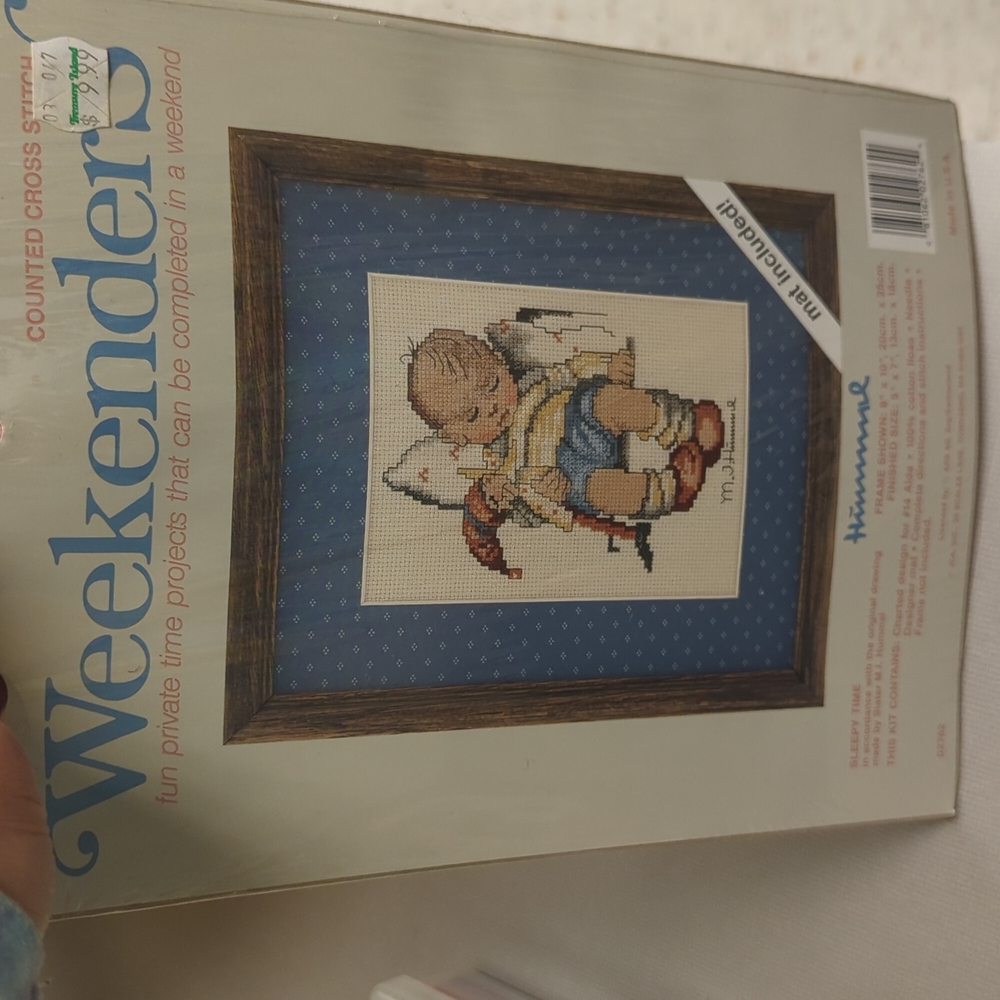Counted Cross stitch embroidery of baby sleeping with mat.